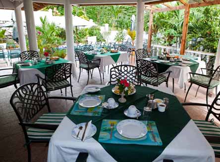 Take breakfast beside the pool at Hanneman Apartments in Seychelles