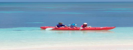 Children having fun in the sea at Desroches Seychelles